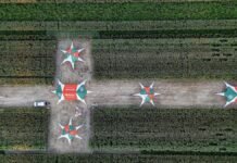 El maíz ajusta decisiones: nuevos híbridos y manejo técnico buscan mejorar rindes en la campaña 2026/27 Vista aérea de lote demostrativo de maíz con estaciones técnicas en evento SupraRoad en Balcarce, evaluación de híbridos y manejo agrícola en campo.