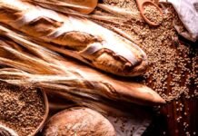 La Rural desafía el argumento del pan: el trigo explica apenas el 6,7% de su precio final Trigal maduro combinado con panes artesanales recién horneados en panadería argentina, representando la cadena del trigo y la producción alimentaria.